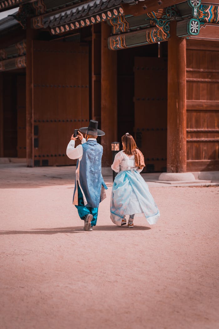 Couple wearing hanbok takes photos at Korean temple in Seoul.