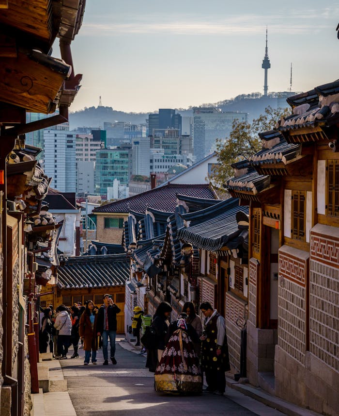 Traditional architecture meets modern skyline at Bukchon Hanok Village, Seoul.